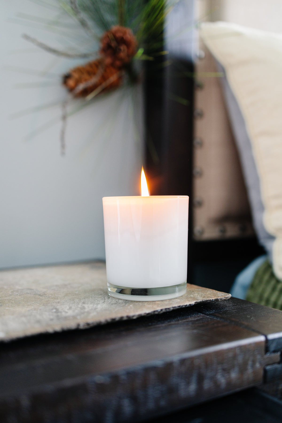 Lighted candle on nightstand