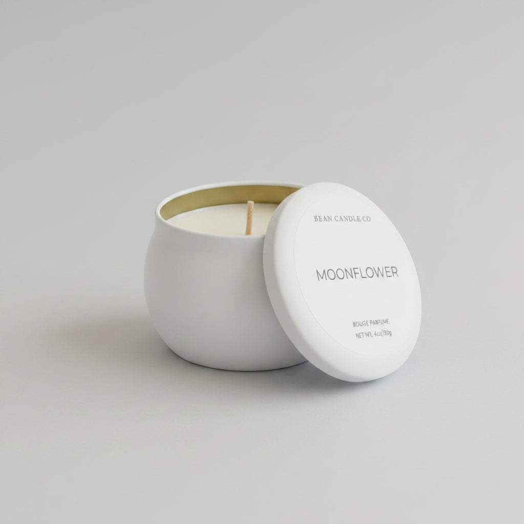 Moonflower candle in a white container with lid on a light gray background