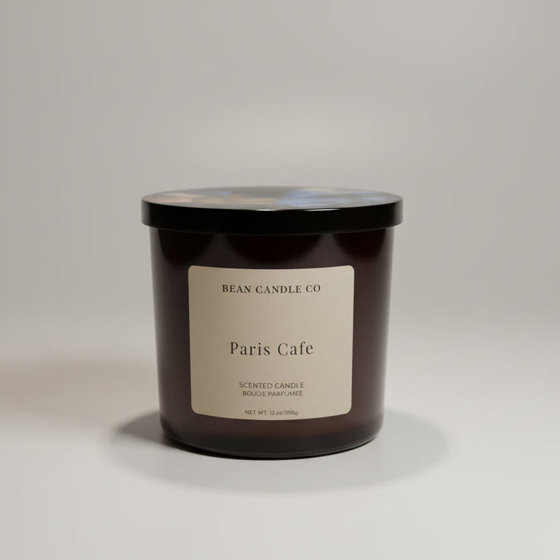Black candle jar with 'Paris Cafe' label on a white background
